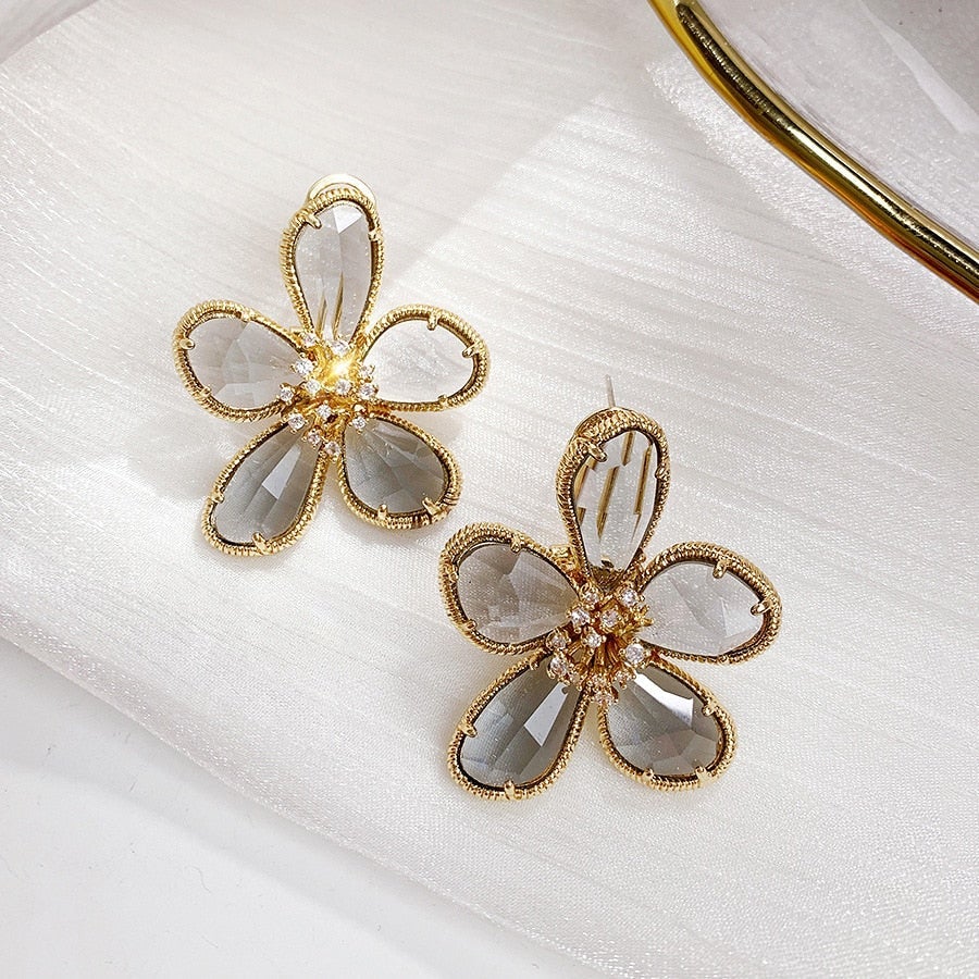 Boucles d'oreilles rotatives ornées de zirconium en forme de fleur de la richesse